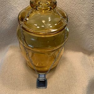 Silver tone with black pendant